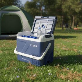 Blue cooler box with drinks on a grassy field near a tent