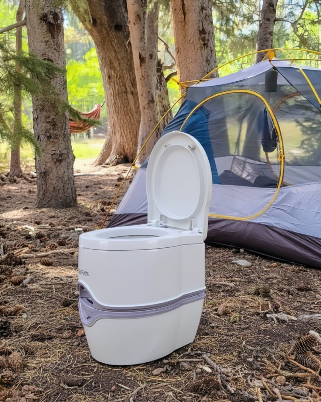 Portable toilet outdoors near a camping tent in a forest setting